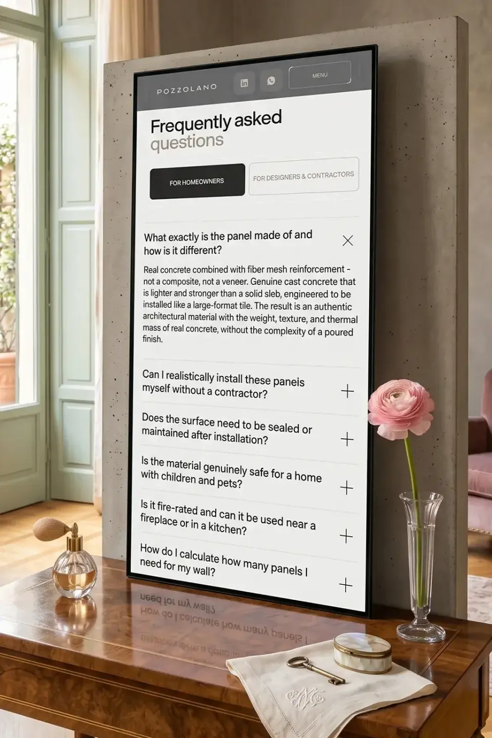 Pozzolano FAQ page on a large vertical display in a showroom