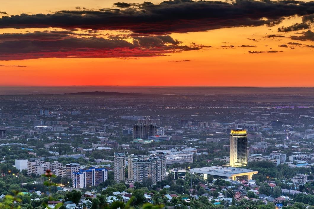 Almaty city glowing at sunset